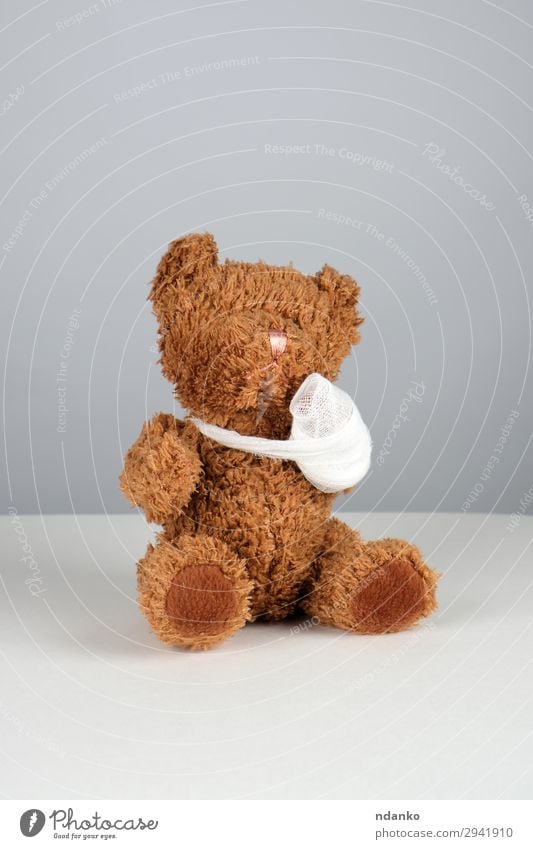 brown teddy bear with a bandaged paw Medical treatment Illness Medication Child Hospital Infancy Arm Band Toys Teddy bear Sit Small Funny Cute Brown White Pain