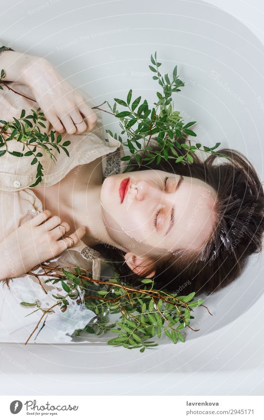 Female lying in bathtub with pistachio branches Tub Attractive Swimming & Bathing Bathroom Bathtub Beautiful Branch Personal hygiene Caucasian Woman Flower