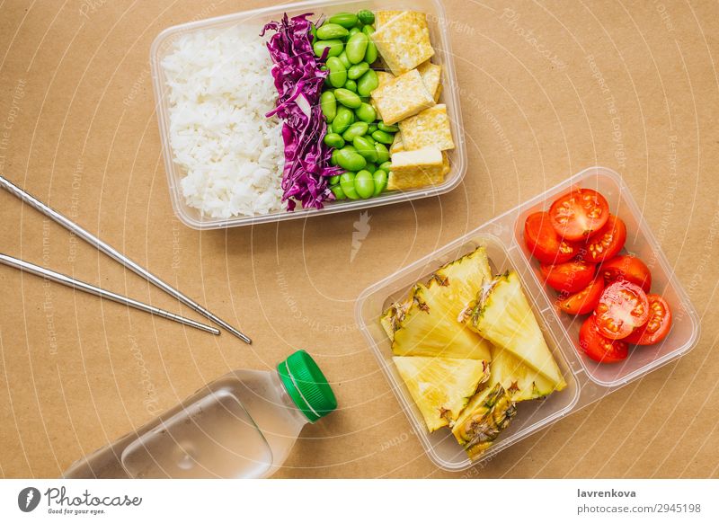 Healthy asian-style vegan bento box Green Bottle Water flat lay cherry tomatoes Cut Pineapple Red cabbage Tasty Cooking metal chopsticks take away lunch box