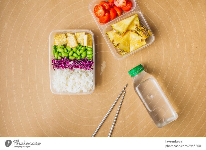 Healthy asian-style vegan bento box Green Bottle Water flat lay cherry tomatoes Cut Pineapple Red cabbage Tasty Cooking metal chopsticks take away lunch box