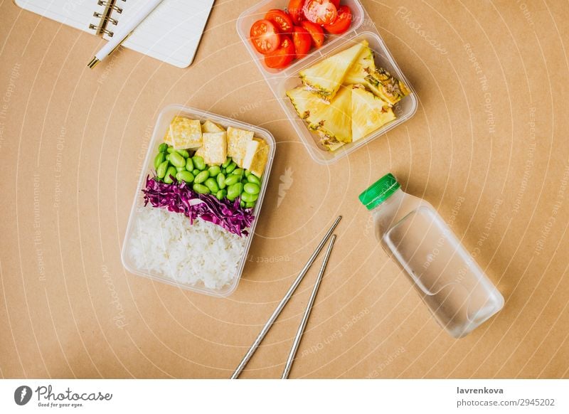 Healthy asian-style vegan bento box Pen Notebook Planer Bottle Water flat lay Tomato Cut Pineapple Red cabbage Tasty Chopstick takeaway lunch box zero waste