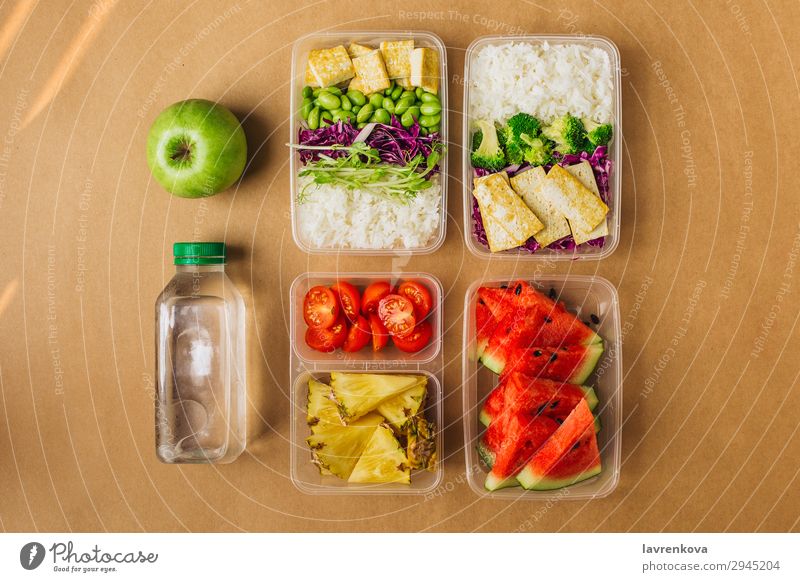 Two healthy asian-style vegan lunch bento boxes Organic Container Nutrition School Apple sprouts Broccoli Water melon Asian Food Asian rice dish cherry tomatoes