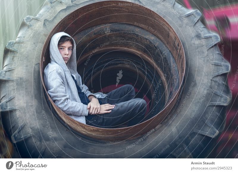 Portrait in a tractor tyre Lifestyle Style Beautiful Well-being Senses Relaxation Adventure Work and employment Workplace Human being Masculine Young man