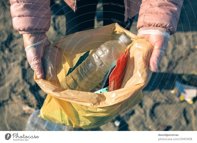 Woman showing garbage collected from the beach Beach Child Work and employment Human being Adults Hand Environment Sand Plastic Dirty Teamwork Indicate