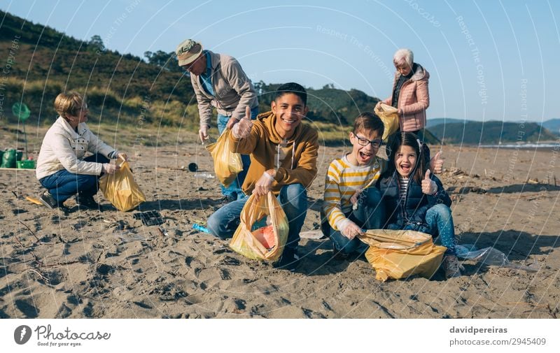 Young man and children cleaning the beach Happy Beach Child Human being Man Adults Family & Relations Youth (Young adults) Group Environment Sand Plastic