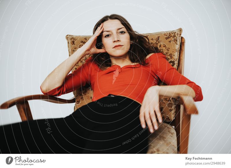 Woman in a red shirt sits on an old chair Lifestyle Luxury Elegant Style pretty Wellness Contentment Relaxation Leisure and hobbies Living or residing