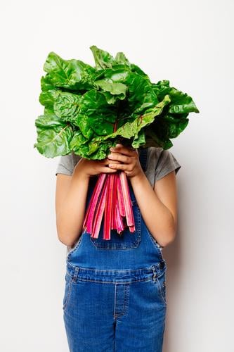 Vegan girl holding a bunch of swiss cahrd Vegetable Nutrition Vegetarian diet Diet Child Leaf Fresh Natural Green Red White chard swiss chard rainbow chard