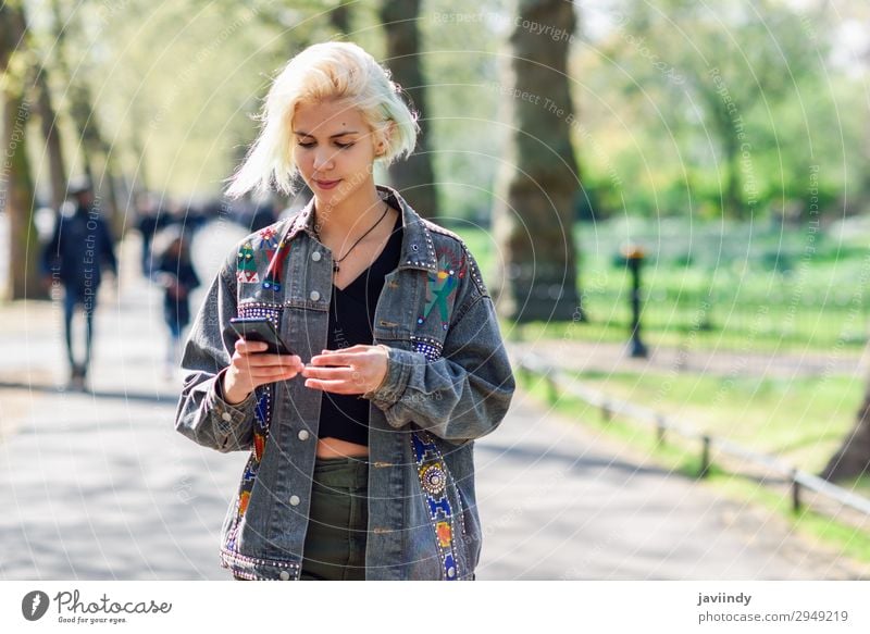 Young urban woman with modern hairstyle using smartphone Lifestyle Happy Vacation & Travel Telephone PDA Technology Human being Feminine Young woman