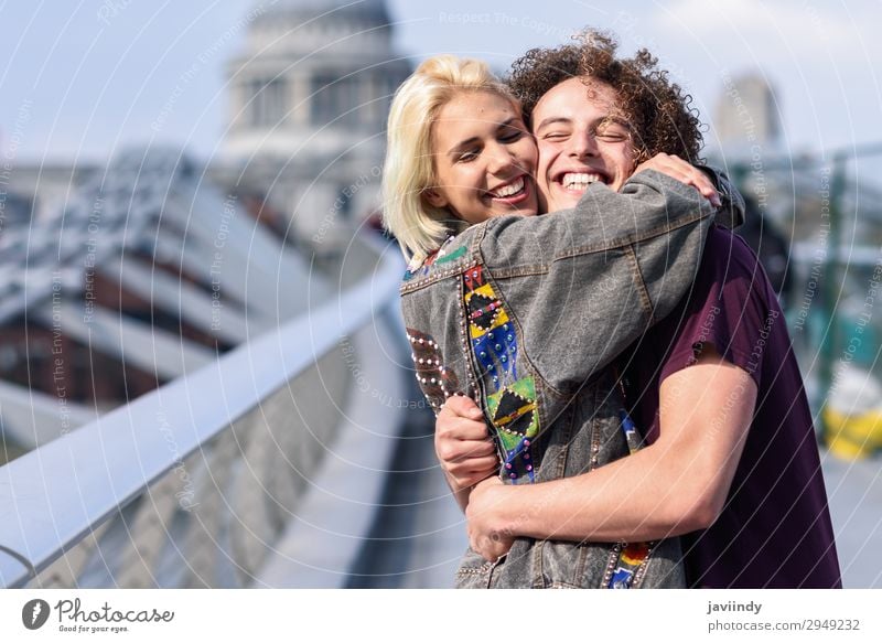 Happy couple hugging by Millennium bridge, River Thames, London. Joy Human being Masculine Feminine Young woman Youth (Young adults) Young man Woman Adults Man