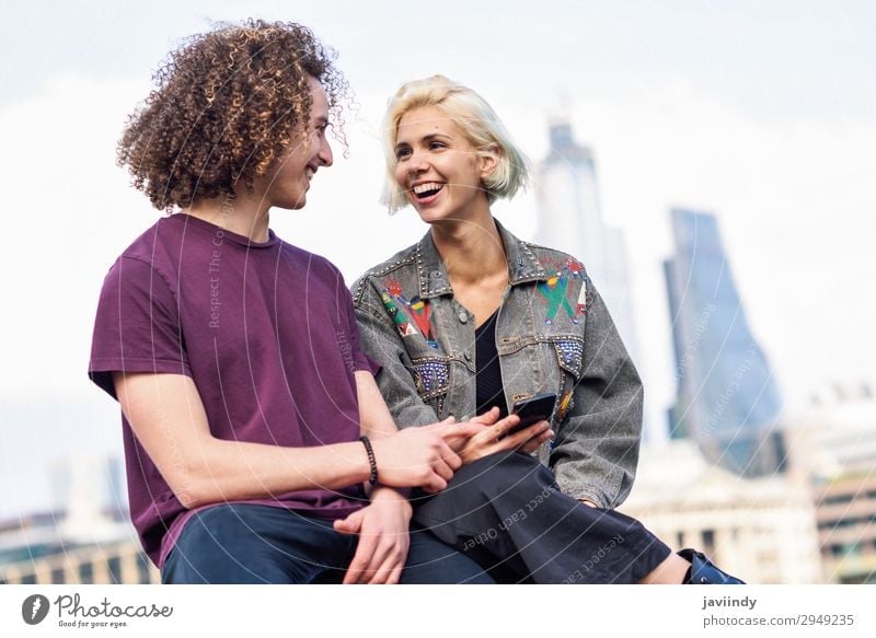 Happy couple talking sitting near River Thames Lifestyle Joy Hair and hairstyles To talk Telephone PDA Technology Human being Masculine Feminine Young woman