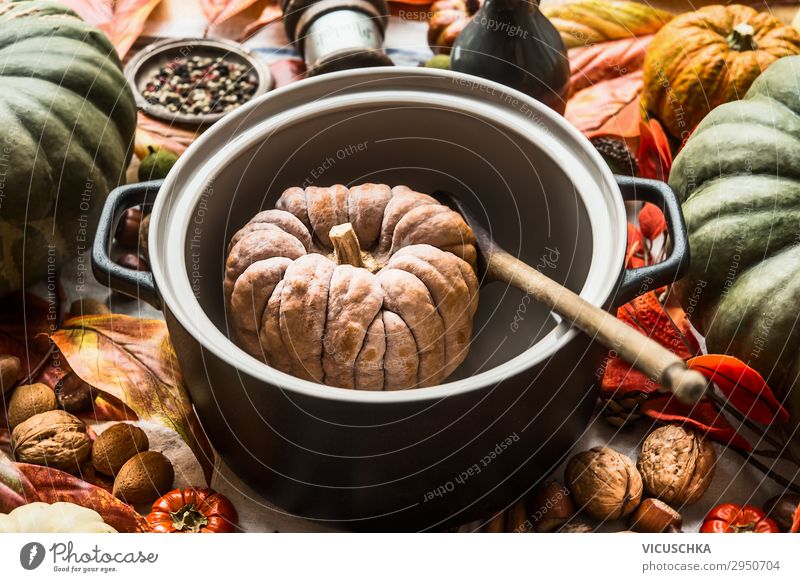 Pumpkin in cooking pan with wooden spoon. Autumn seasonal cooking and eating. Close up. Traditional fall recipes pumpkin autumn close up traditional background