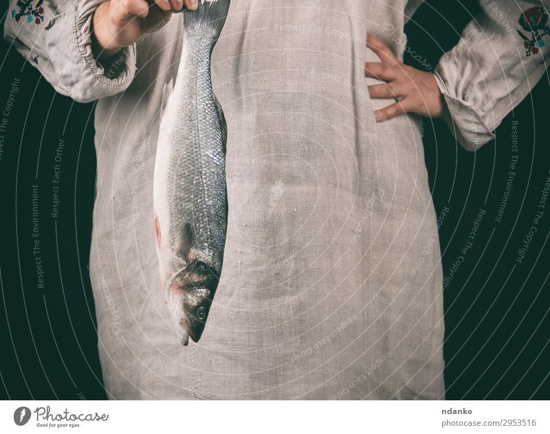 woman in gray clothes holding a fresh sea bass fish Fish Seafood Kitchen Human being Woman Adults Hand 1 18 - 30 years Youth (Young adults) Make Stand Fresh