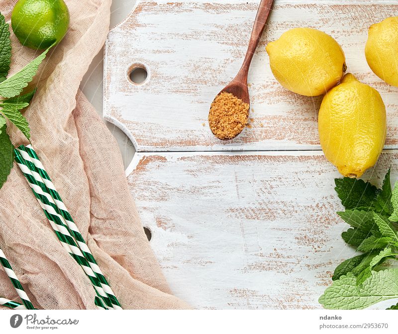 ripe yellow whole lemons and lime Fruit Herbs and spices Nutrition Vegetarian diet Lemonade Juice Spoon Summer Table Plant Leaf Tube Wood Fresh Natural Above