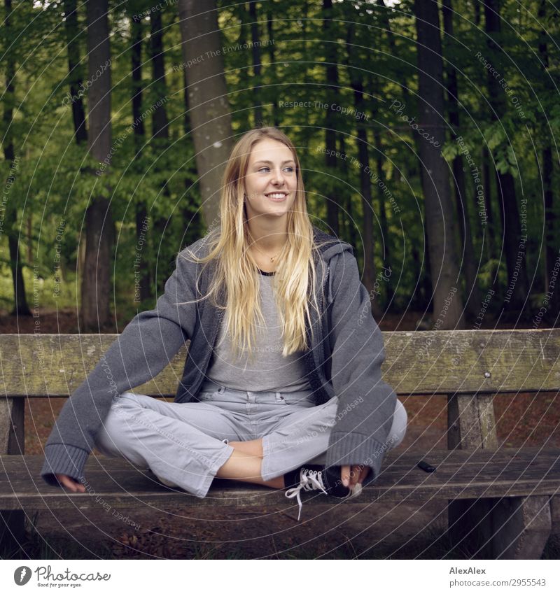 Blonde girl sitting on a bench in the woods Joy pretty Wellness Life Leisure and hobbies Young woman Youth (Young adults) 18 - 30 years Adults Environment
