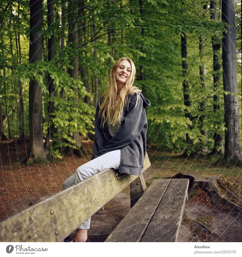 Young woman sitting smiling on a bench in a forest Style Joy pretty Life Harmonious Youth (Young adults) 18 - 30 years Adults Nature Landscape Beautiful weather