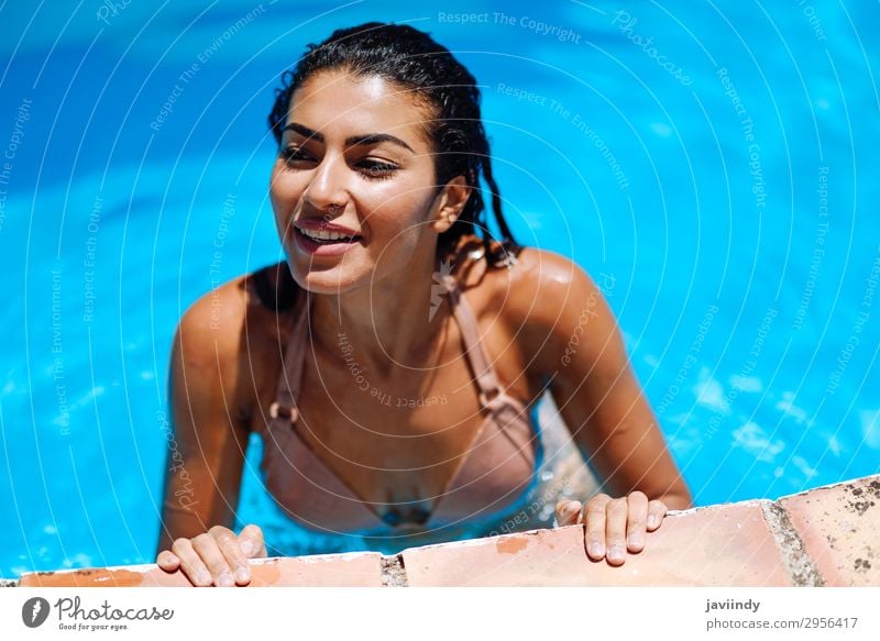 Happy young woman relaxing in swimming pool. Lifestyle Beautiful Body Hair and hairstyles Skin Relaxation Swimming pool Leisure and hobbies Vacation & Travel