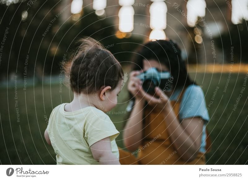 Mother and daughter taking photos with camera at sunset Lifestyle Vacation & Travel Summer Summer vacation Camera Human being Feminine Child Baby Toddler Girl