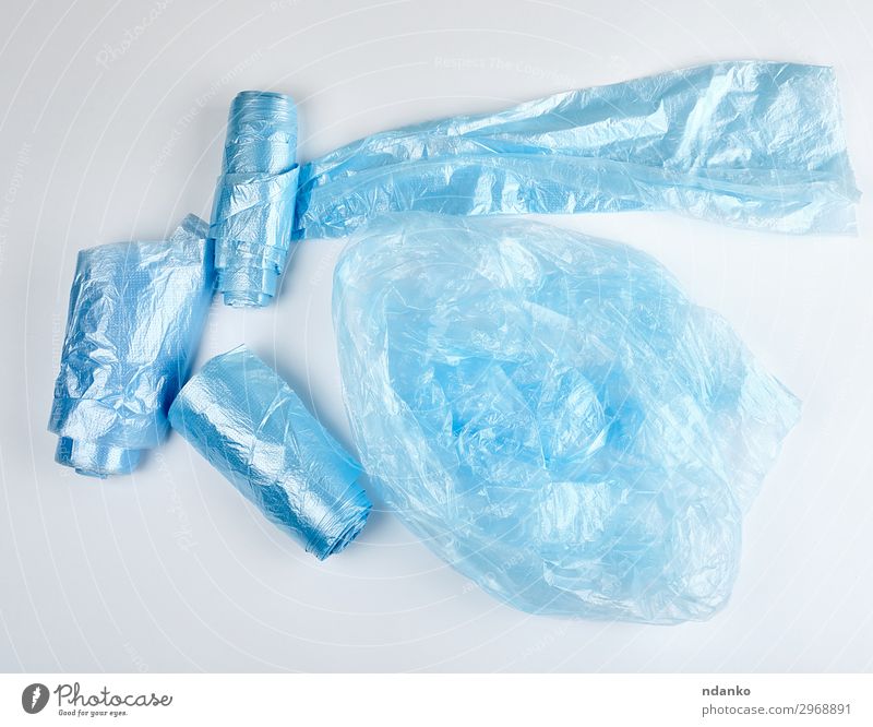 blue plastic bags for garbage on a white background Environment Container Package Sack Plastic New Clean Blue White Colour Environmental pollution bin
