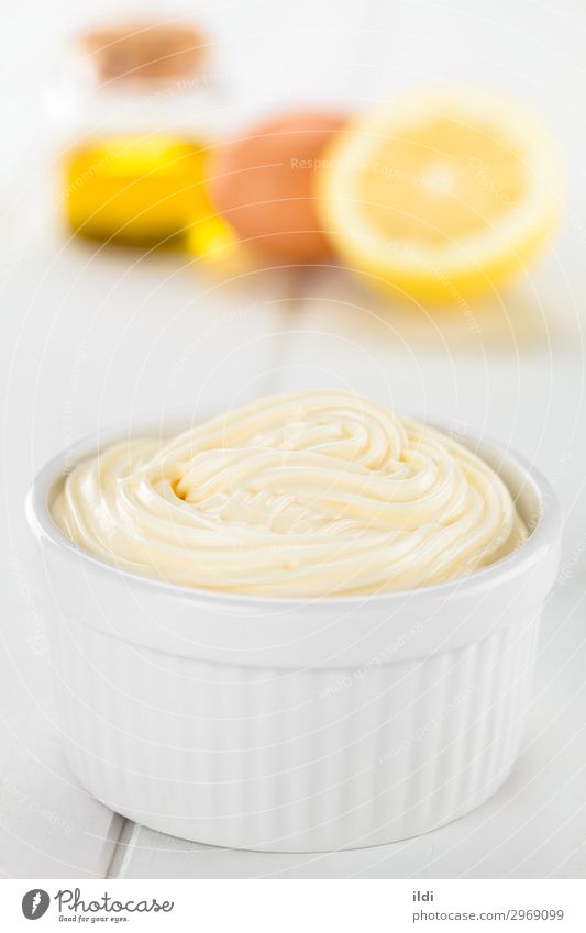Mayonnaise Food Bowl Fat mayo condiment Sauce cream Dip dressing Ingredients Creamy savory Swirl Spread oil egg Lemon ramekin white wood Vertical ingredient