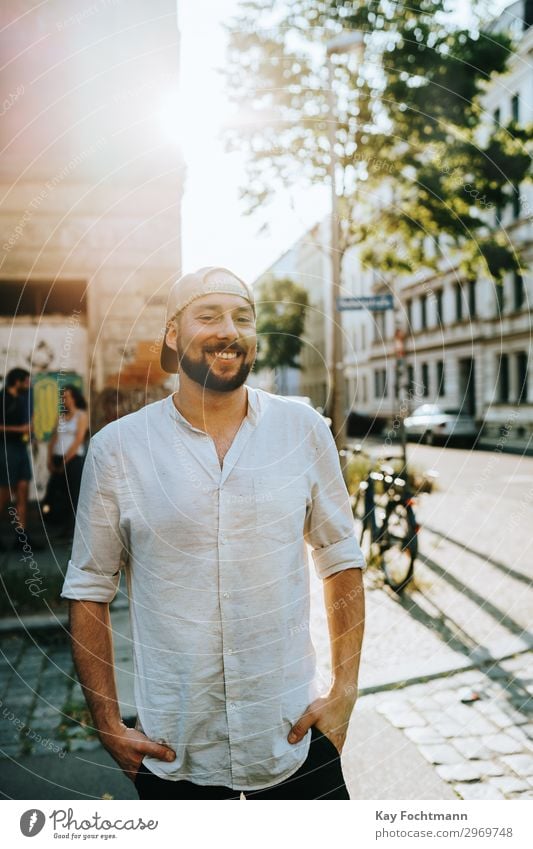 smiling bearded man in summertime attractive baseball cap casual caucasian cheerful citylife confident cool emotion expression face fashion friendly grinning