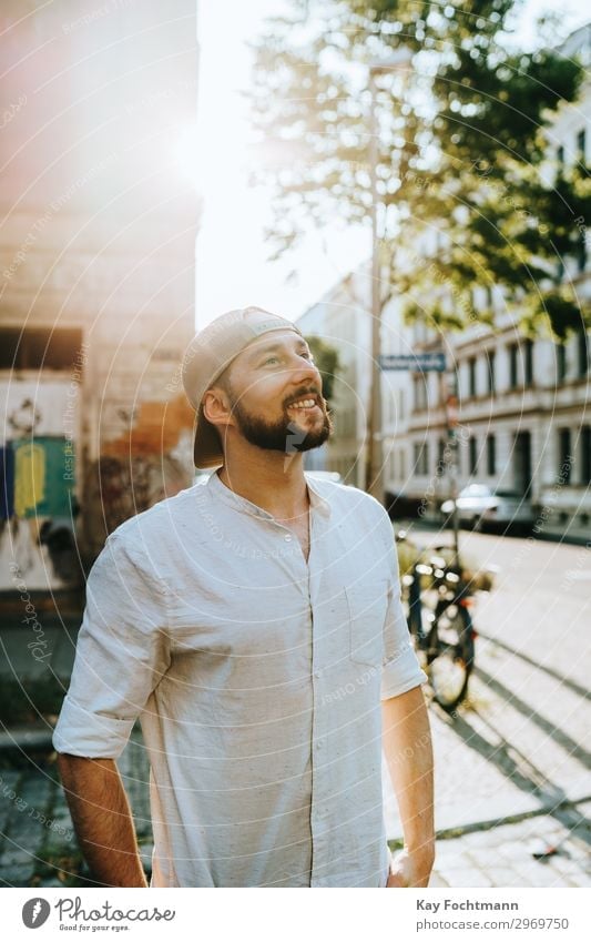 man standing on the street in summer time attractive baseball beard bearded cap casual caucasian cheerful citylife confident cool emotion expression face