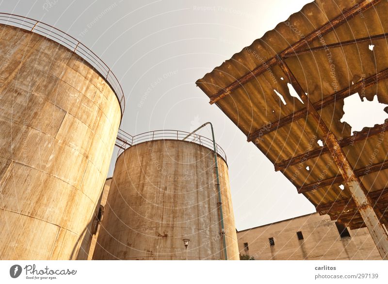 old, crooked and broken .... Cloudless sky Summer Warmth Industrial plant Factory Manmade structures Facade Roof Old Silo Tank Storehouse Corrugated sheet iron