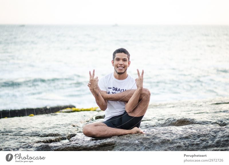 Attractive peruvian young man practicing yoga Body Wellness Sun Beach Ocean Sports Yoga Human being Man Adults Sit Muscular Flexible Action asana ashtanga bend