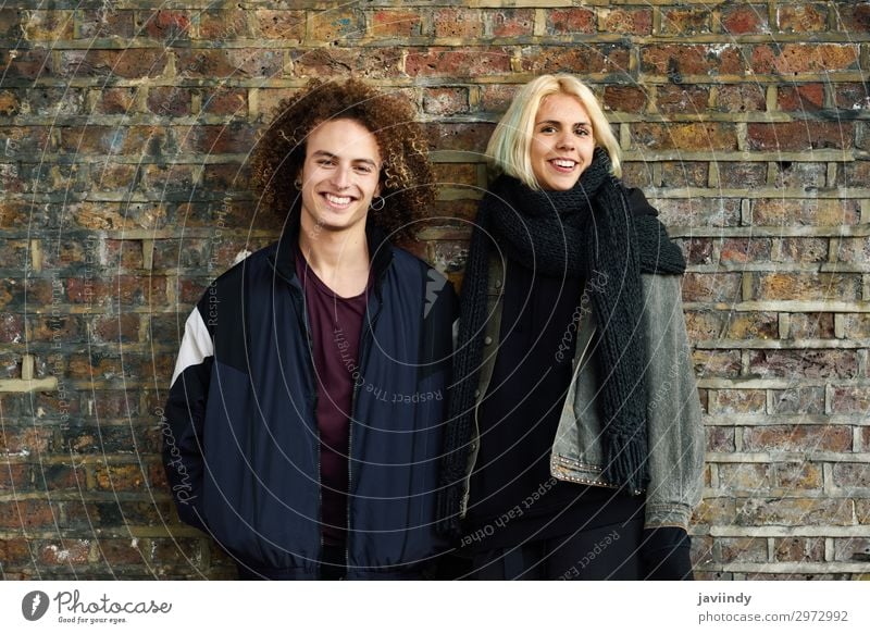 Young couple enjoying Camden town in front of a brick wall typical of London Joy Happy Hair and hairstyles Vacation & Travel Tourism Human being Masculine