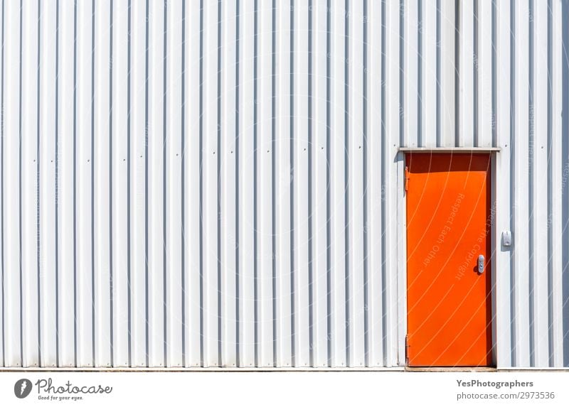 Orange metal door and a white warehouse wall - a Royalty Free Stock Photo  from Photocase