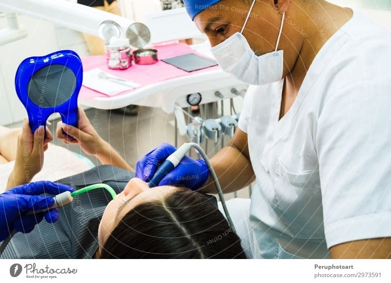 Dentist and his assistant examining a patient Lifestyle Happy Health care Medication Examinations and Tests Work and employment Profession Doctor Office