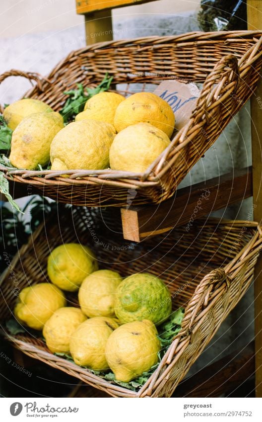 Fresh lemons in flat buskets, placed on a rack Fruit Yellow Lemon citrus Napoli Italy Basket market mart Crate no person Still Life Mature Vertical Colour photo