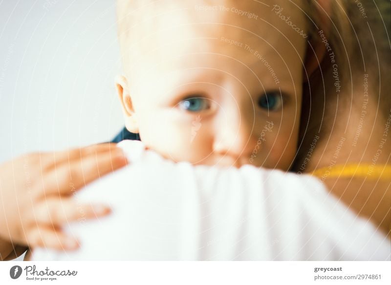 An unfocused portrait of a blue-eyed baby, hugging its mother, who is holding it in her arms Child Human being Feminine Baby Girl Young woman