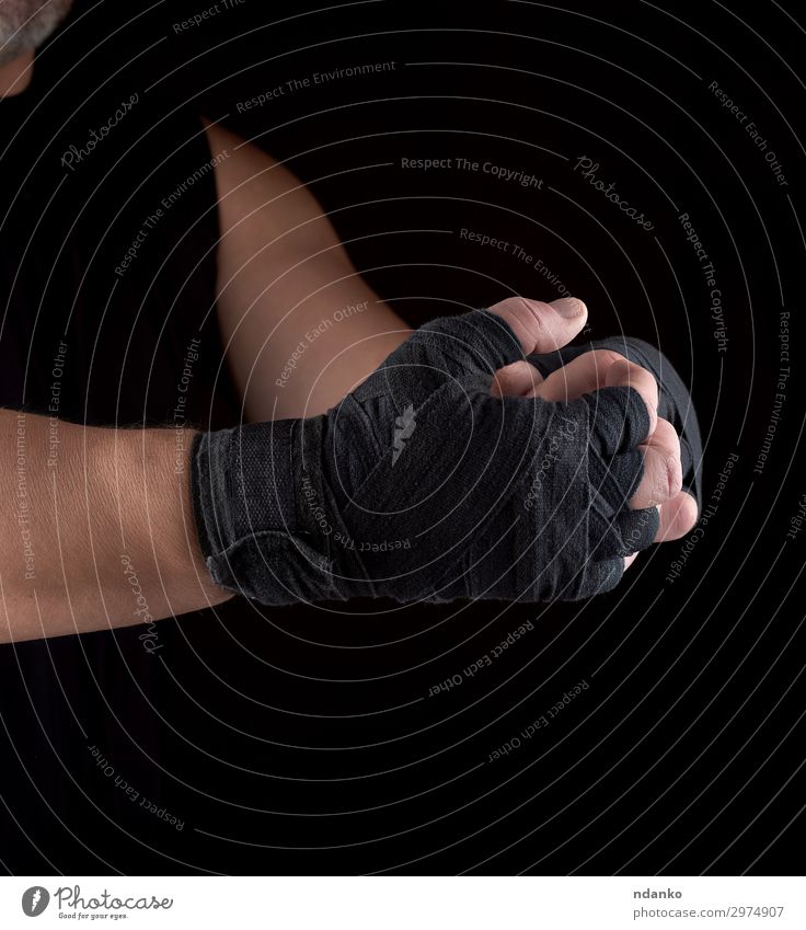 hands wrapped in black sports textile bandage Lifestyle Body Sports Human being Man Adults Arm Hand Fitness Aggression Dark Strong Black Power Might Action