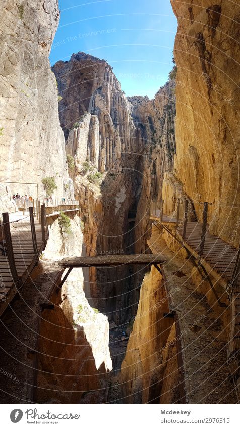 Caminito del Rey Human being Group Environment Nature Landscape Sky Cloudless sky Sun Sunlight Summer Beautiful weather Warmth Drought Rock Canyon Andalucia