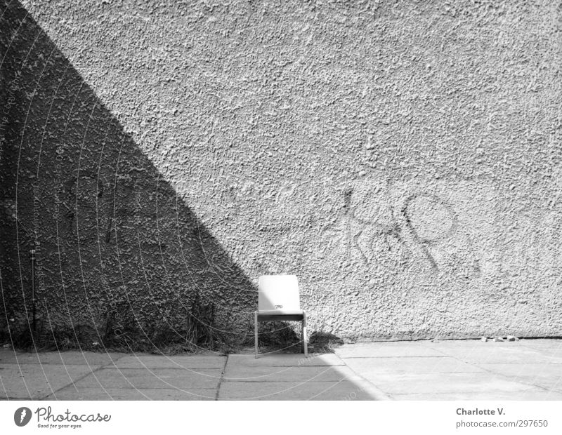 chair Wall (barrier) Wall (building) Chair Concrete Wood Characters Graffiti Stand Simple Retro Gray Black White Calm Authentic Unwavering Modest Curiosity