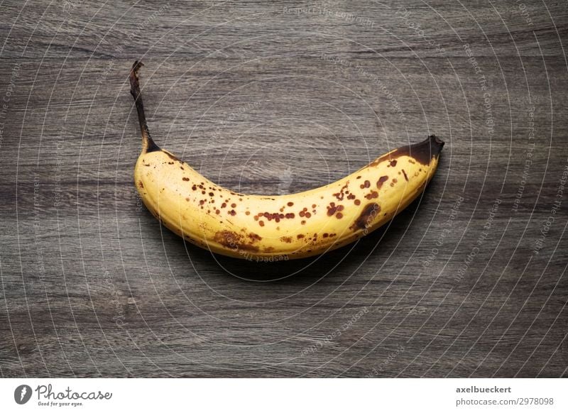 overripe banana on rustic wood background Food Fruit Nutrition Vegetarian diet Healthy Eating Old Brown Yellow Snack Banana Mature Patch Wood Wooden table
