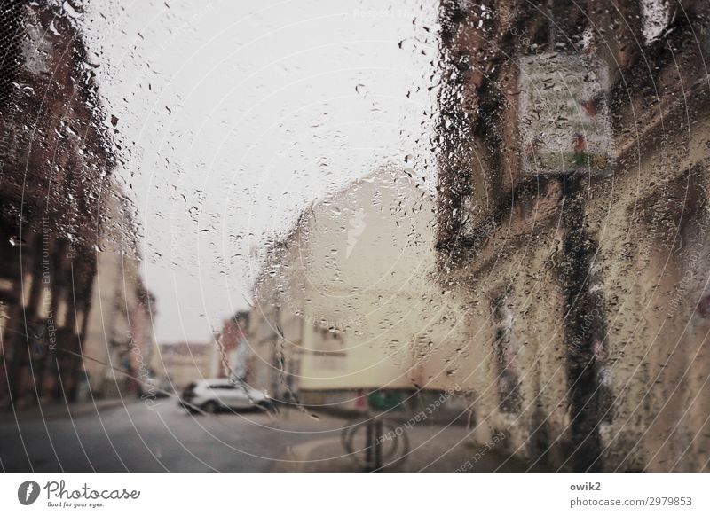 by the rain Water Drops of water Clouds Bad weather Rain Small Town Populated House (Residential Structure) Wall (barrier) Wall (building) Facade Street Car Wet