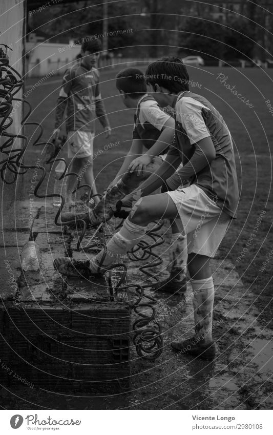 Old and new soocer players Playing Sports Ball Masculine T-shirt Observe Going Joy Climate Black & white photo Exterior shot Day Blur Full-length Looking away