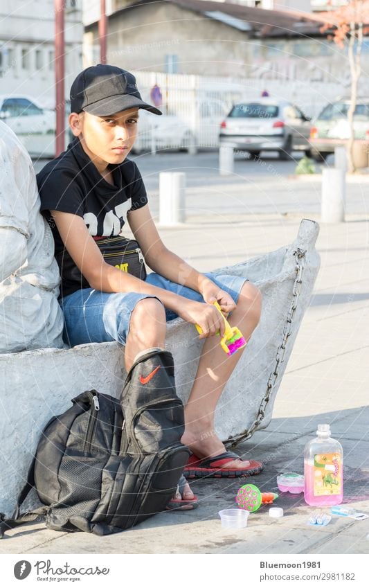 Portrait of a young teenager selling bubble makers Lifestyle Style Leisure and hobbies Vacation & Travel Summer Child Work and employment Business Boy (child) 1