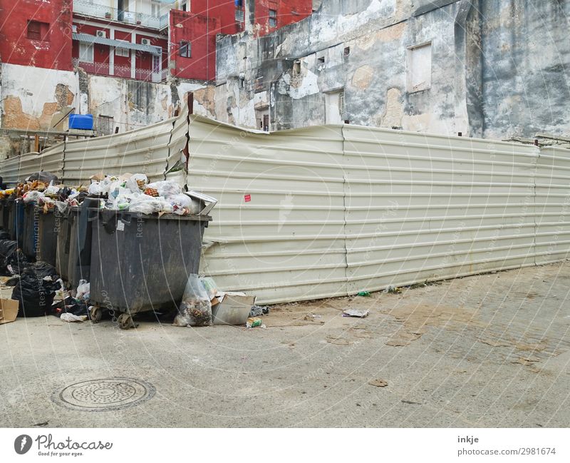 on the corner of Cuba Town Outskirts Deserted Places Building Facade Fence Trash container Waste management Refuse disposal Authentic Crowded Full Dirty Poverty