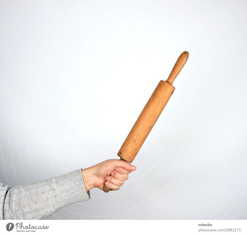 hand holding a wooden rolling pin Beautiful Body Kitchen Tool Human being Woman Adults Arm Hand Fingers Wood To hold on Large Gray White Caucasian chef cook