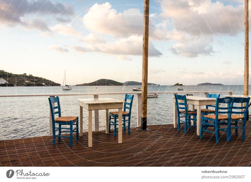 Empty tables in a restaurant by the sea Vacation & Travel Tourism City trip Summer Summer vacation Ocean Island Chair Table Restaurant Services Gastronomy Sky