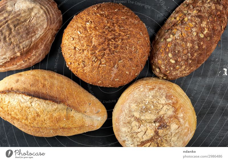 baked various loaves of bread Bread Nutrition Eating Breakfast Diet Table Wood Dark Fresh Delicious Natural Above Brown Black Tradition Baking Bakery board