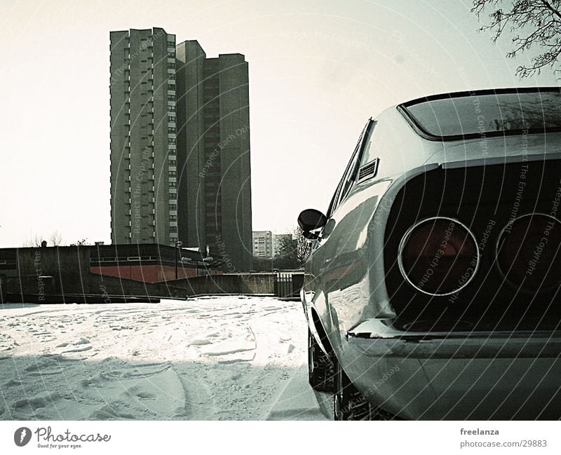 My block Vintage car High-rise Retro Snow Rear light Detail Section of image Partially visible Parking Parking lot Winter Car Stern Car body Iconic