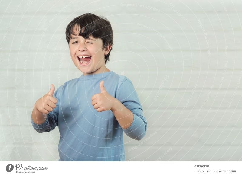 Little Boy Smiling Showing Thumbs Up A Royalty Free Stock Photo