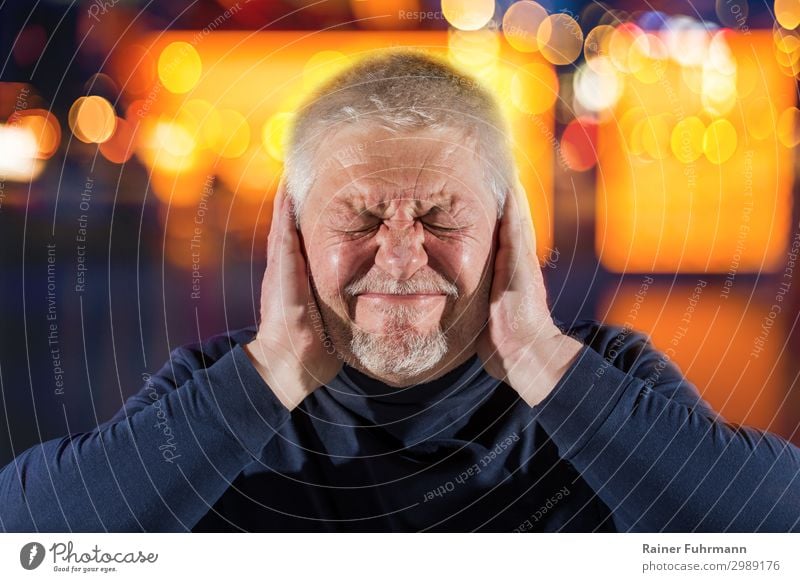 A man suffers from disturbing noises. He has tinnitus. Bright lights surround him. Human being Masculine Man Adults Male senior Head 1 Event Shows