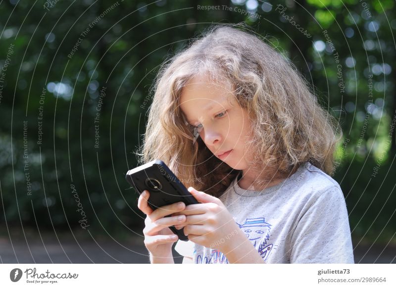 In another world | Cool boy with long hair immersed in his cell phone... Boy (child) Infancy Life 1 Human being 8 - 13 years Child Summer Park Blonde