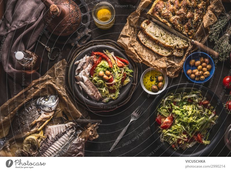 Mediterranean dinner with fried fish Food Fish Nutrition Banquet Crockery Style Design Living or residing Table Restaurant homemade bread olive oil Dorade above