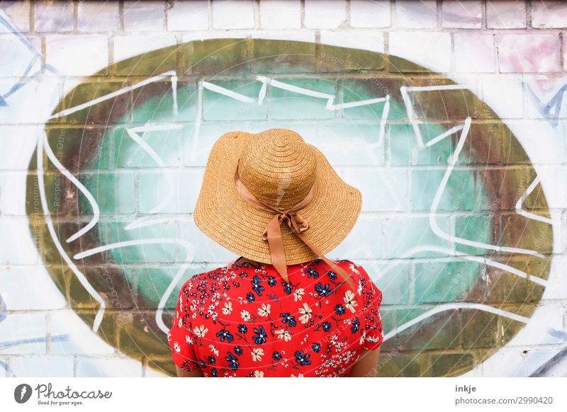 back view woman with straw hat in front of graffiti Lifestyle Elegant Style Leisure and hobbies Young woman Youth (Young adults) Woman Adults 1 Human being