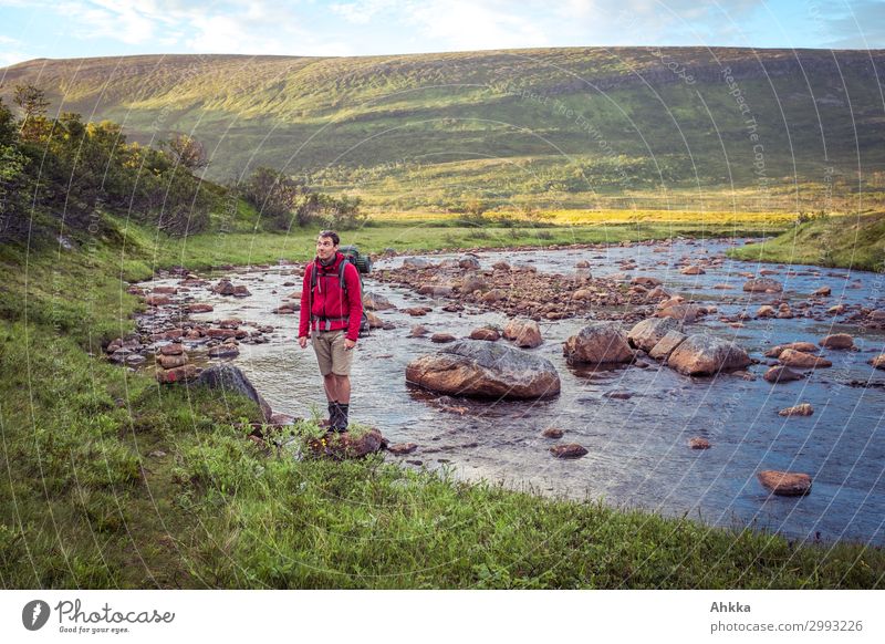 Young hiker in river landscape Vacation & Travel Freedom Mountain Hiking Young man Youth (Young adults) 1 Human being Nature Water Hill Rock River bank Norway